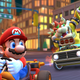 Bowser winds up before throwing his green shell at Mario's kart.